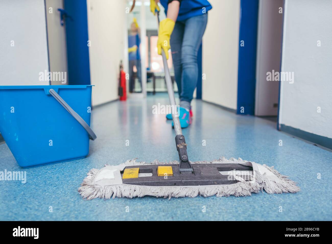 Close-up of cleaners moping the floor Stock Photo