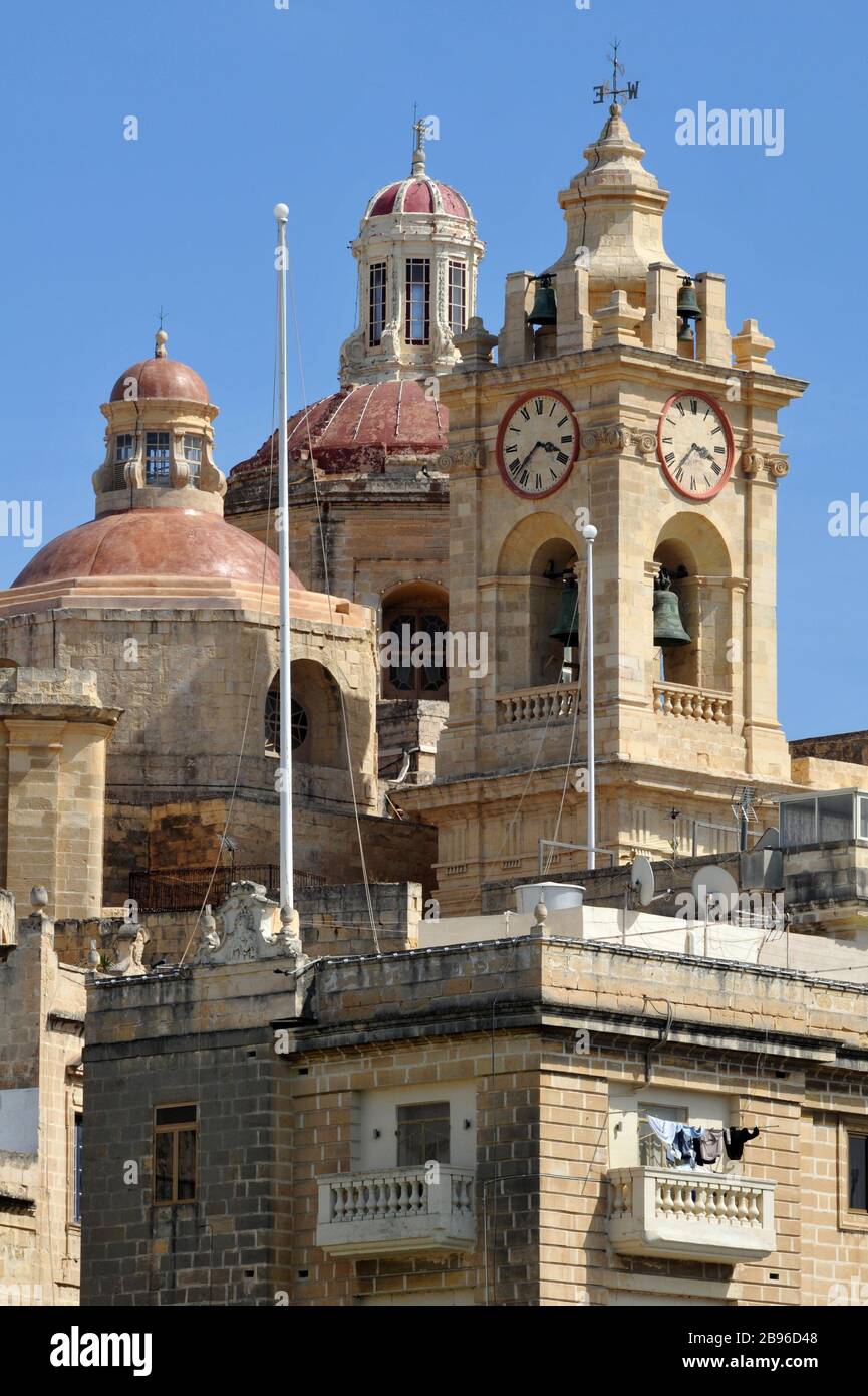 The towers of the Collegiate Church of the Immaculate Conception are a landmark in Cospicua, Malta, one of the Three Cities near Valletta. Stock Photo