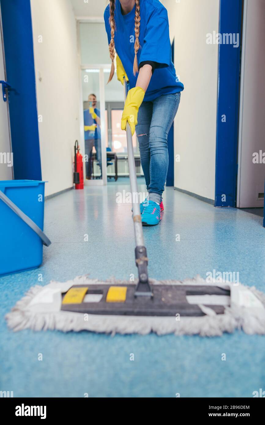 Close-up of cleaners moping the floor Stock Photo