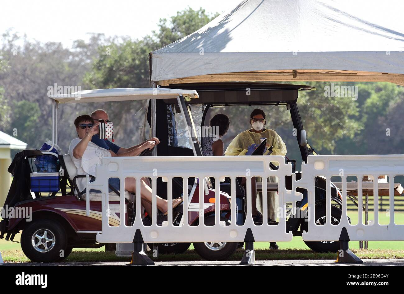 The Villages, Florida, USA. March 23, 2020 - The Villages, Florida, United States - People arrive in golf carts to be tested for the coronavirus on March 23, 2020 at a COVID-19 mobile testing site at The Villages Polo Club in The Villages, Florida. Health workers in this retirement community will operate the testing site for five days. (Paul Hennessy/Alamy) Credit: Paul Hennessy/Alamy Live News Stock Photo