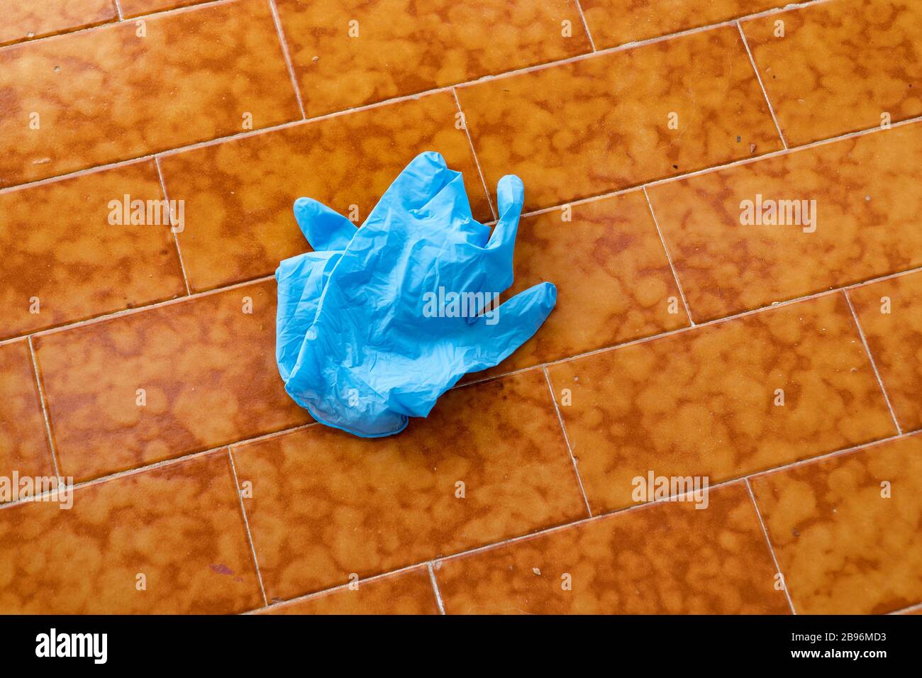 Discarded lying on the floor blue disposable gloves medical. Save