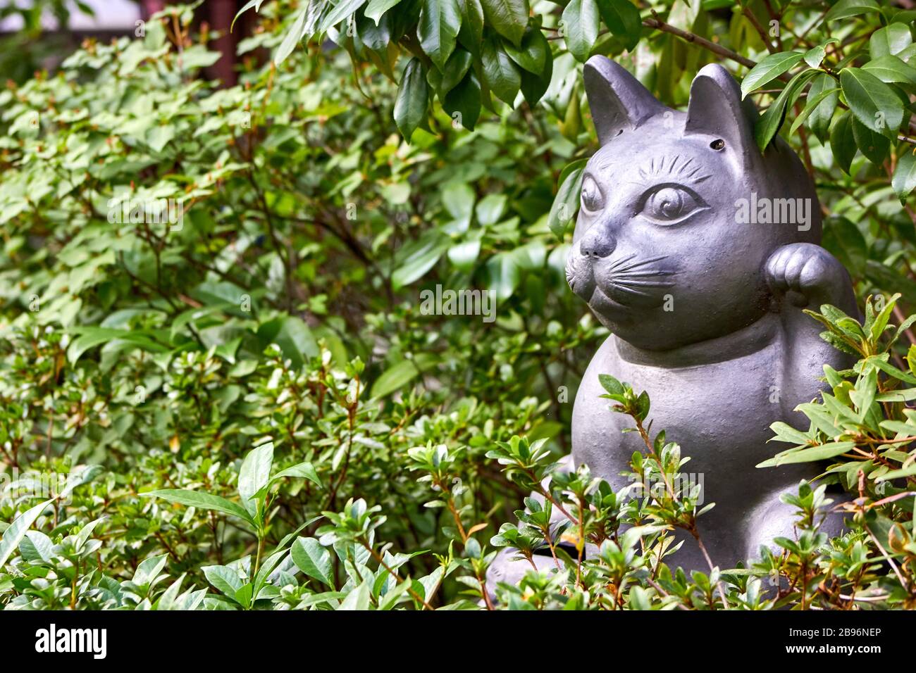 Welcoming cat sculpture in the garden Stock Photo