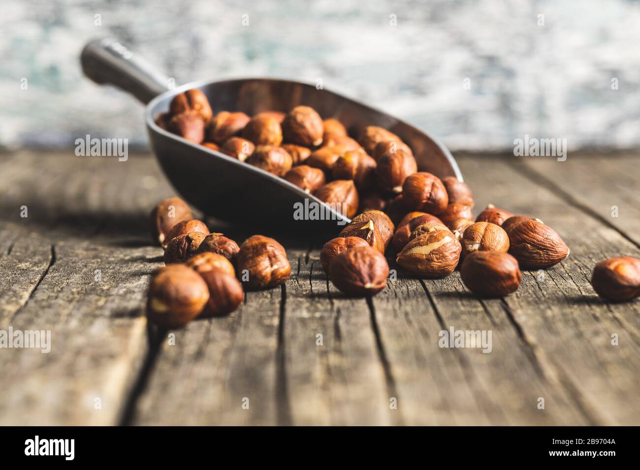 Peeled hazelnuts on old wooden table. Stock Photo