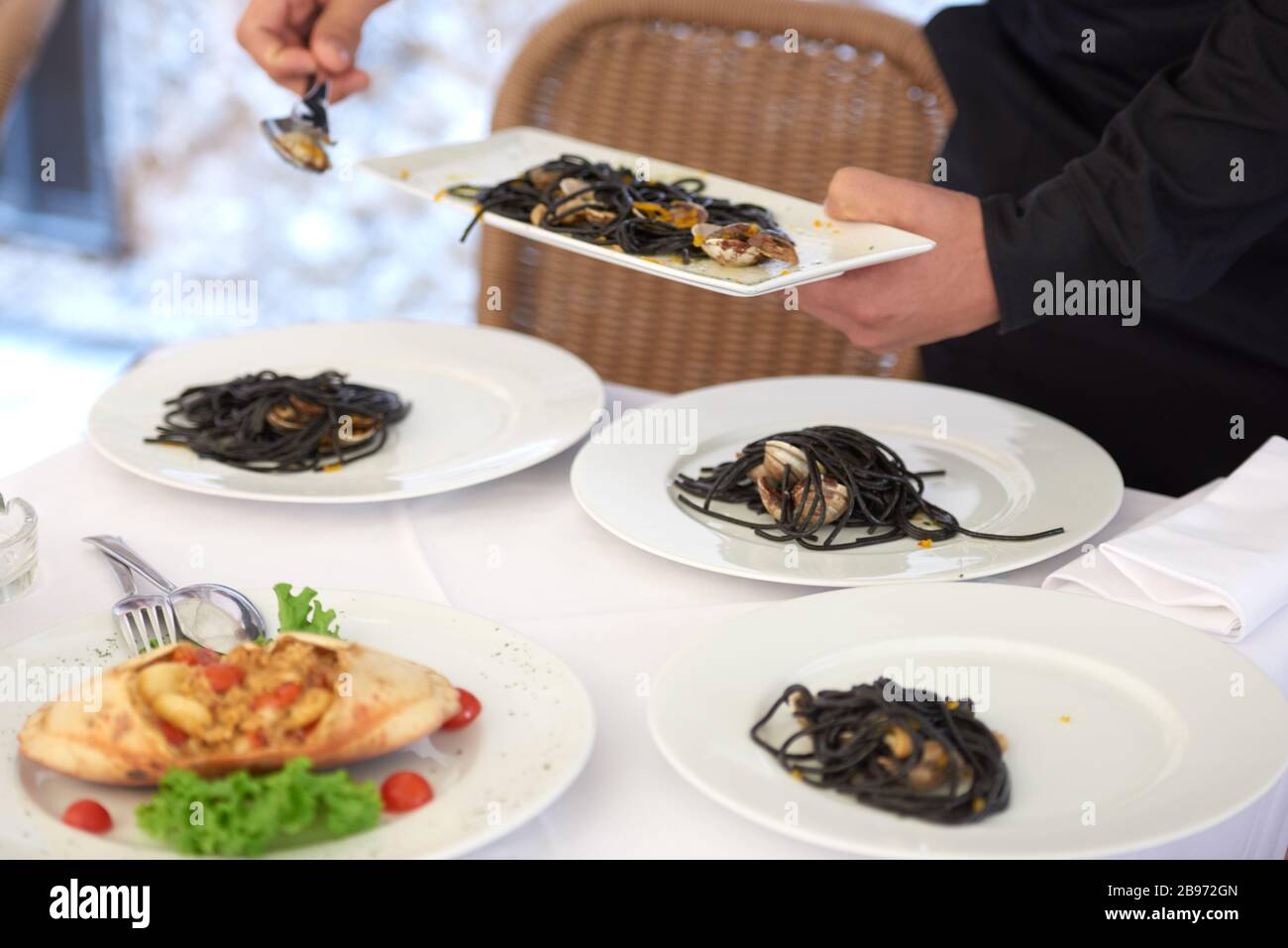 spaghetti with cuttlefish ink with clam sauce and bottarga Stock Photo