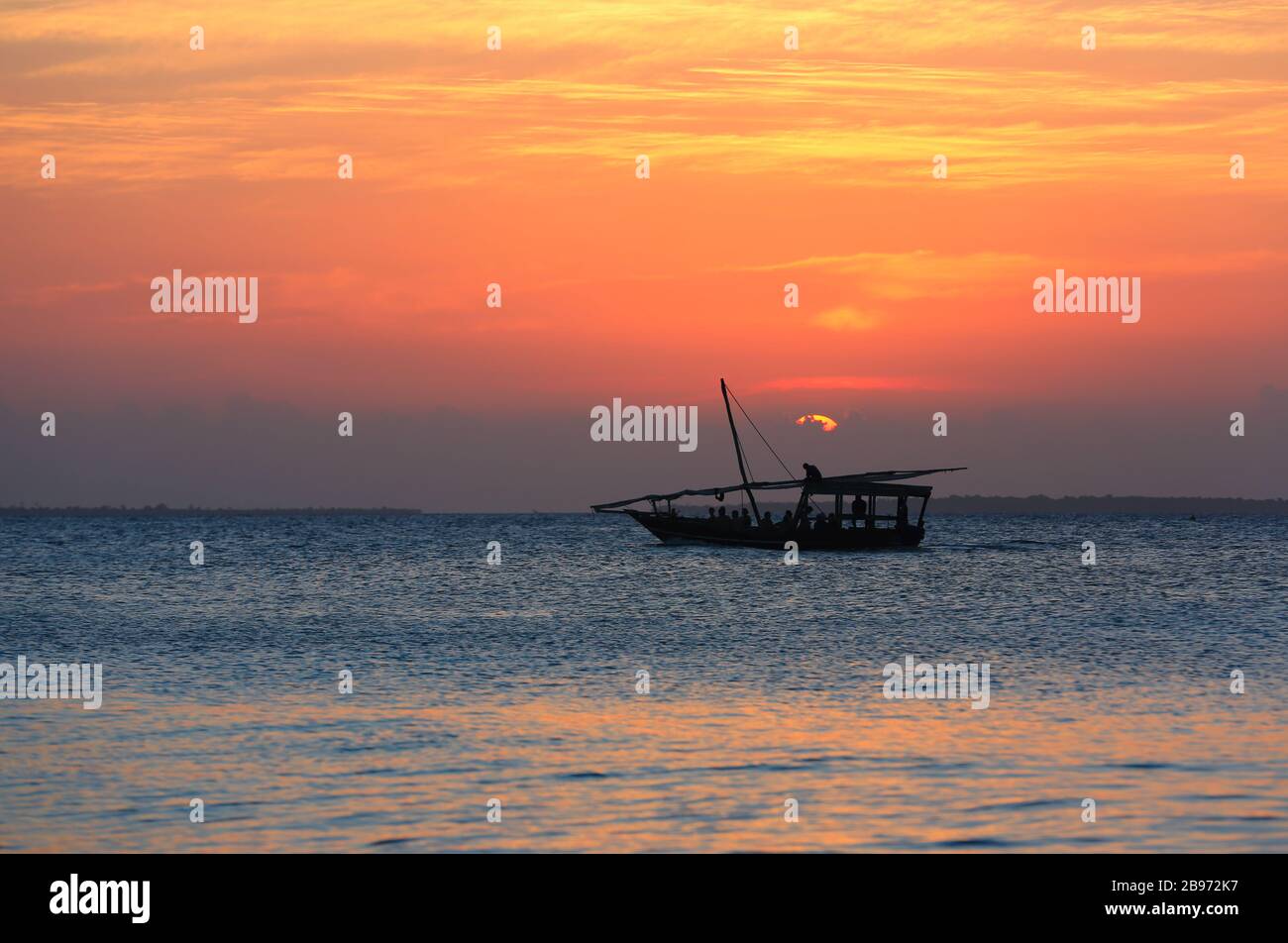 Boat on sea against sunset sky background Stock Photo - Alamy