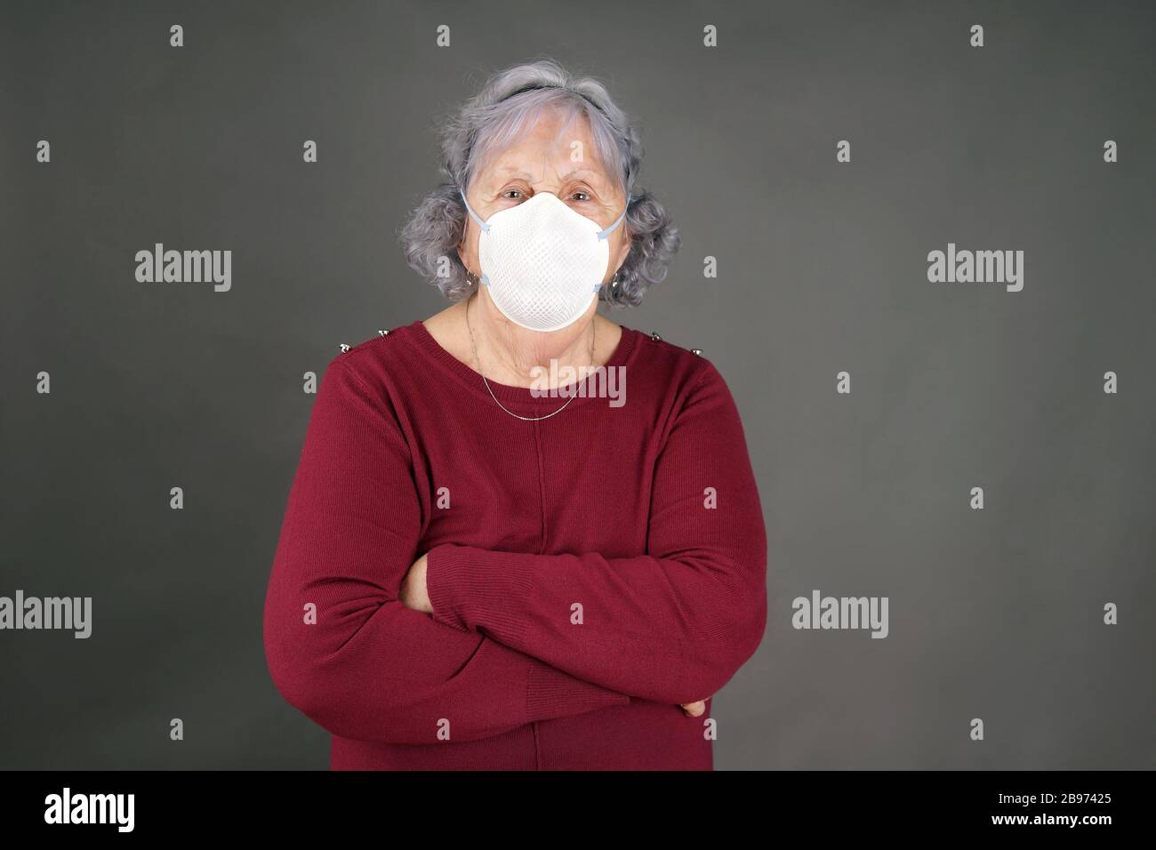 Senior woman with medical mask arms crossed coronavirus pandemic concept Stock Photo