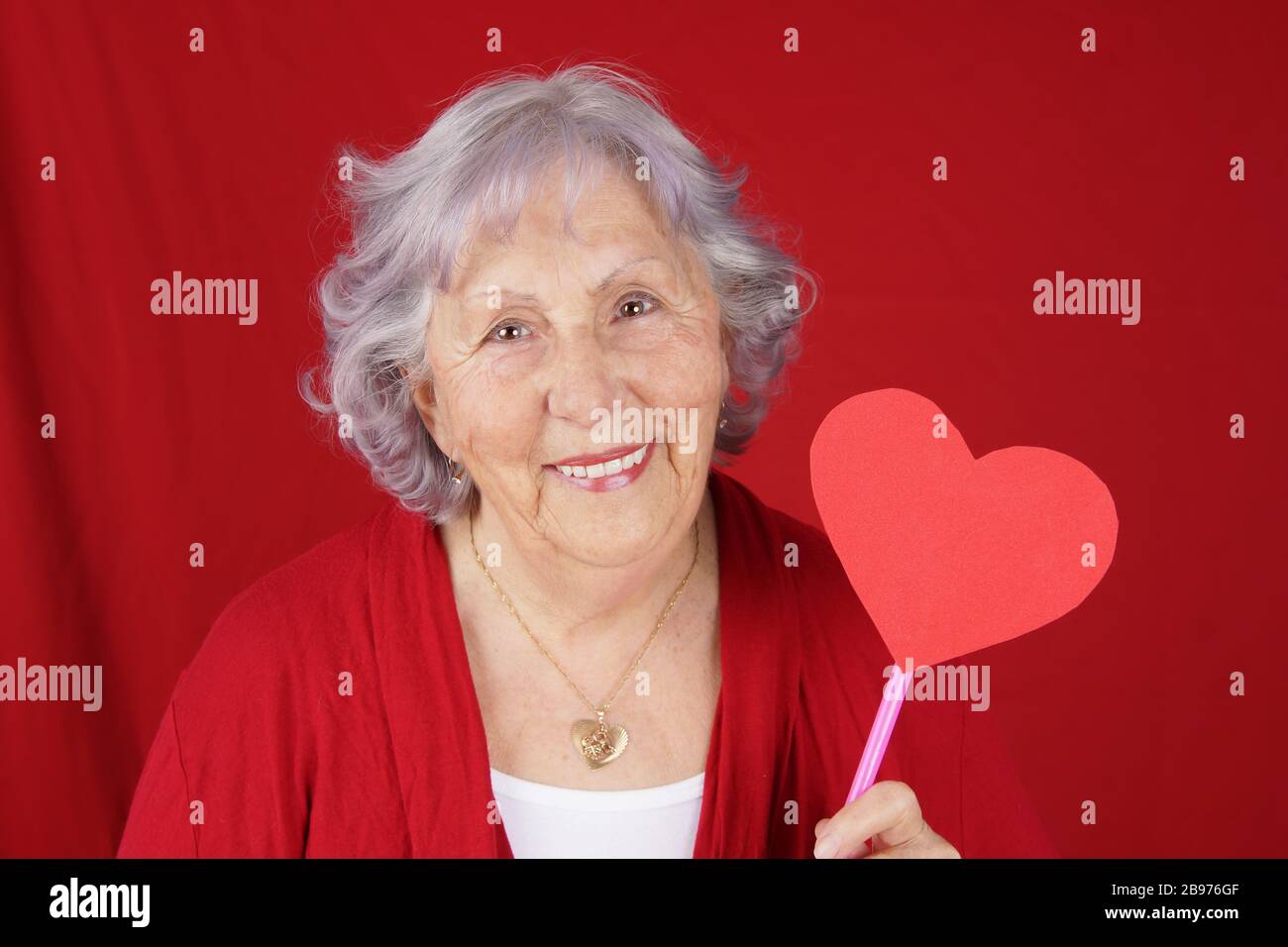 Senior woman or grandma with heart shaped sign, Valentine's day concept Stock Photo