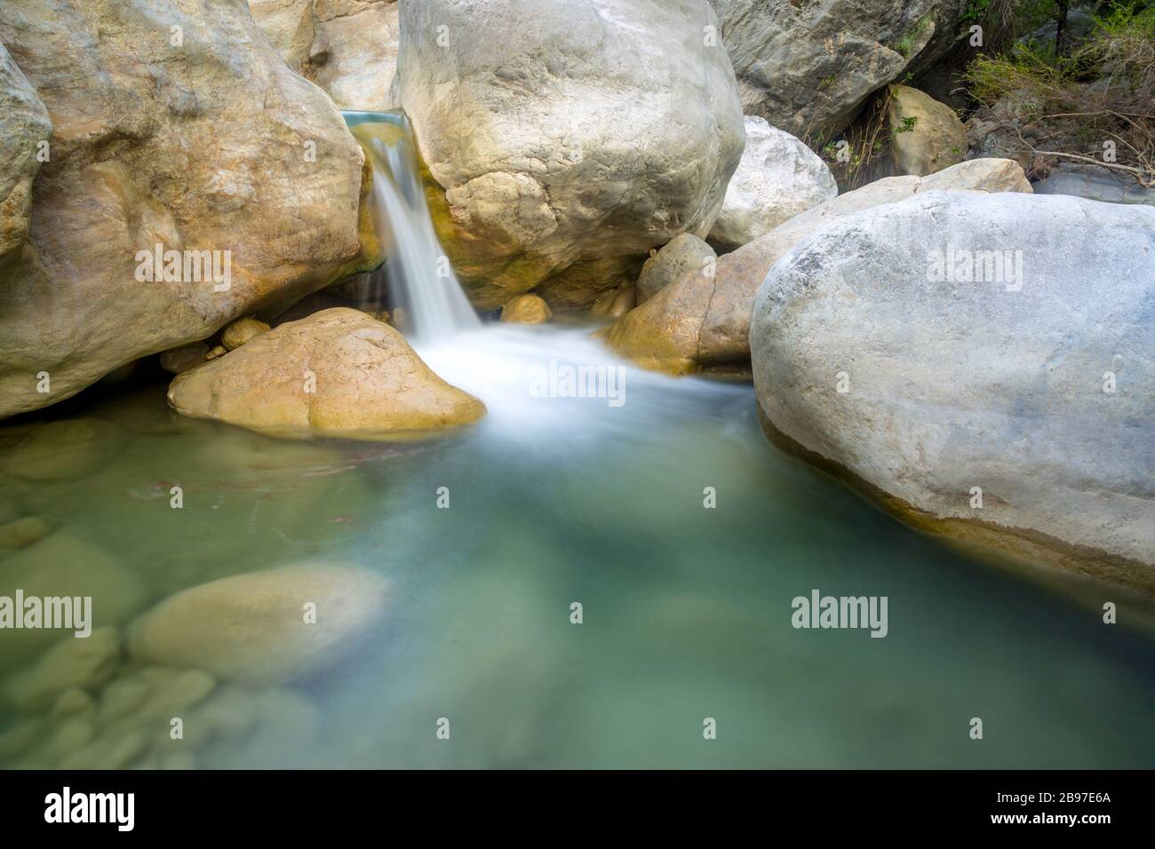 small waterfall among stones on mountain stream Stock Photo