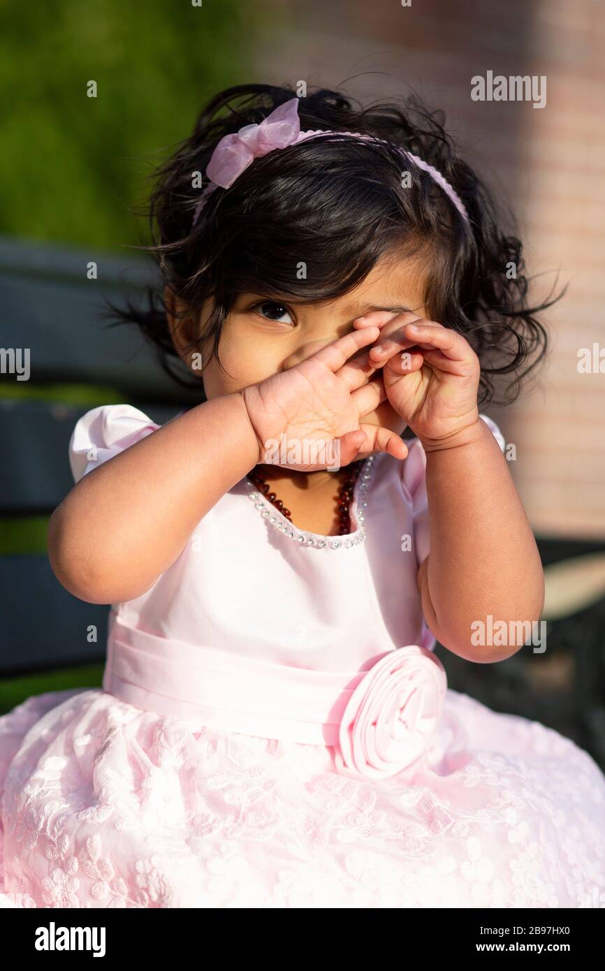 Portrait of an Indian toddler in Auckland Domain, New Zealand Stock Photo