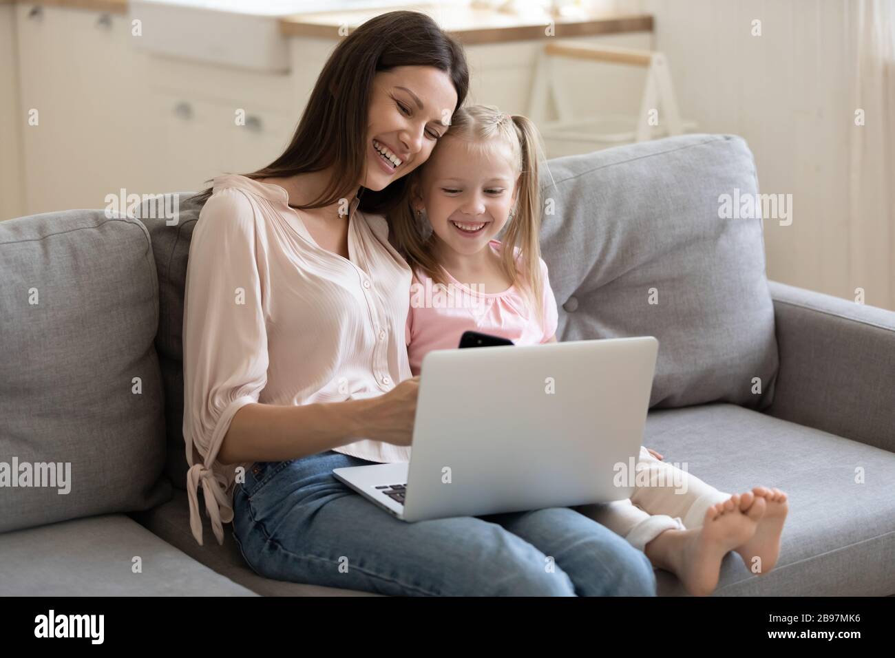 Happy mom and daughter have fun using devices Stock Photo - Alamy