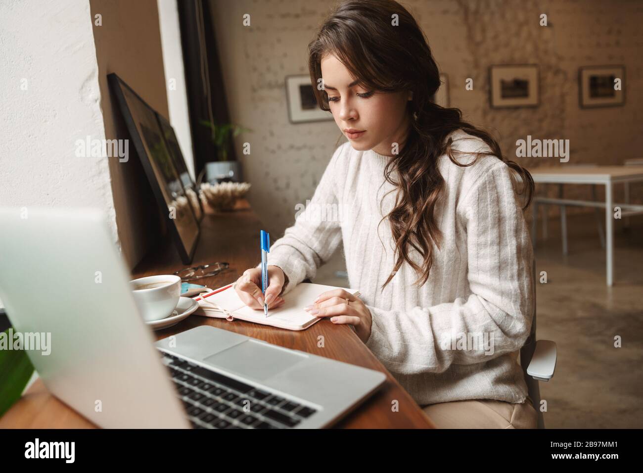Image of young beautiful caucasian woman with long brown hair using ...