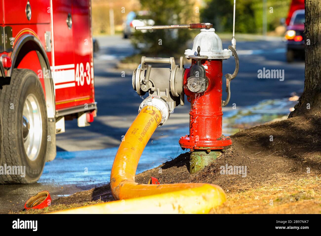 Fire hydrant water supply during emergency hooked to hose at day