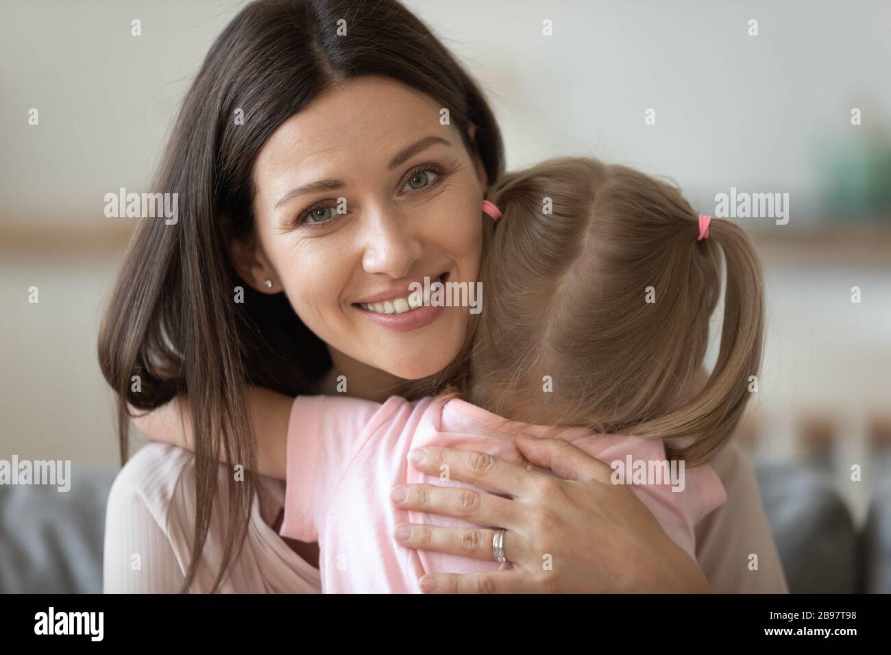 Portrait of happy mom and little daughter hugging Stock Photo