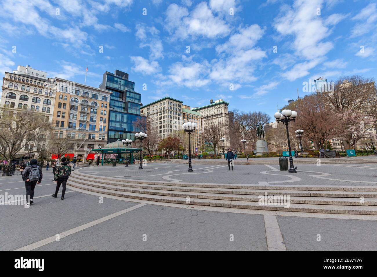 Few people in Union Square and  on the empty streets in New York City because of COVID-19, Coronavirus. Stock Photo