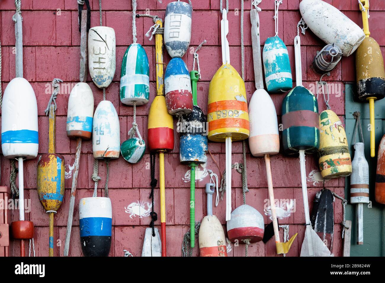 Wooden Lobster fishing buoys hanging on the wall Stock Photo - Alamy