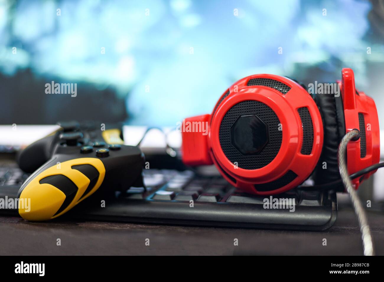 Game pad joystick and Headphones on keyboard playing gaming and watching video on tv or Computer games console concept Stock Photo