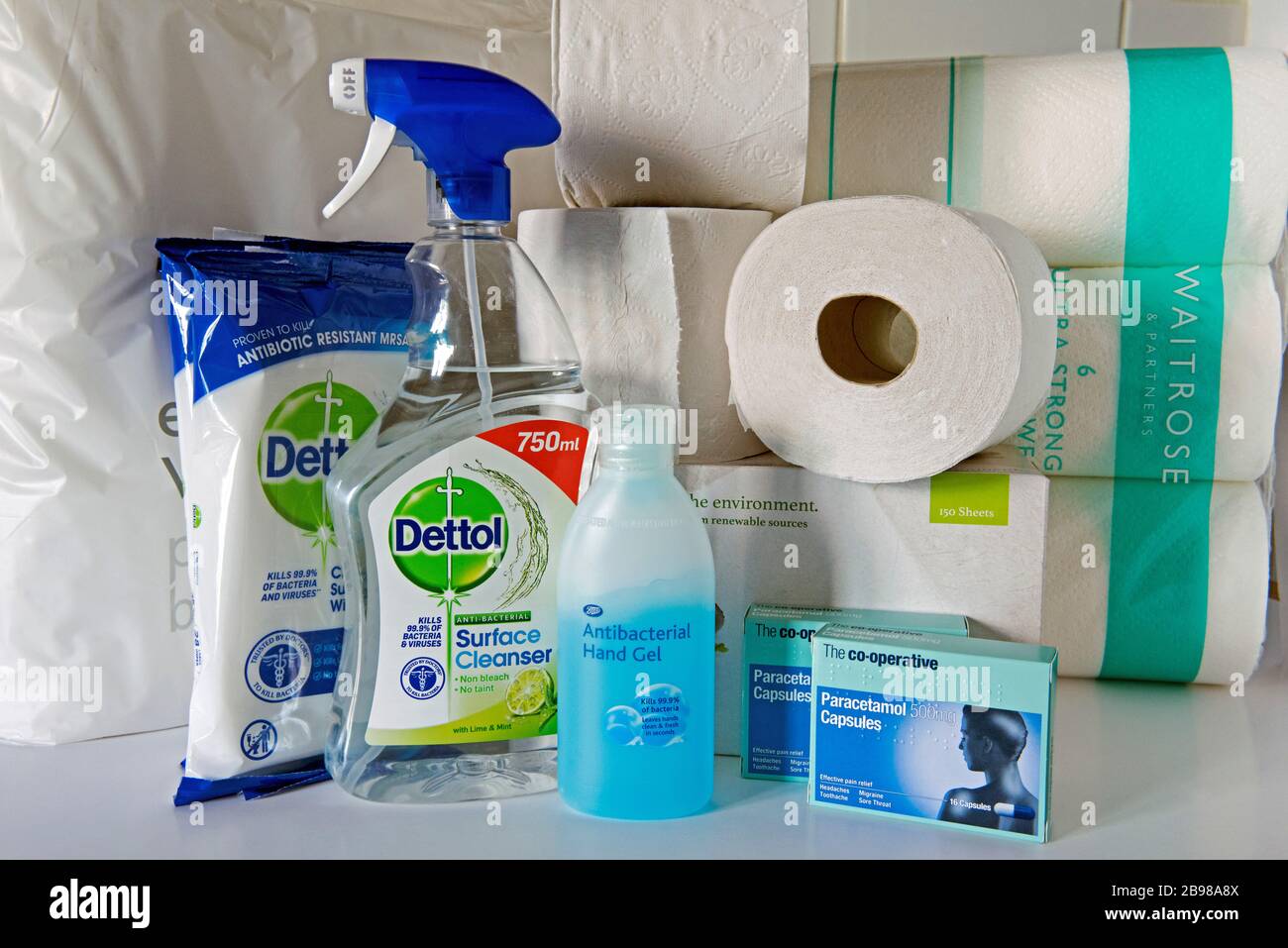 Antibacterial hand gel, Dettol spray and surface wipes to combat coronavirus. Toilet rolls behind and Paracetamol Capsules covid-19 epidemic pandemic Stock Photo
