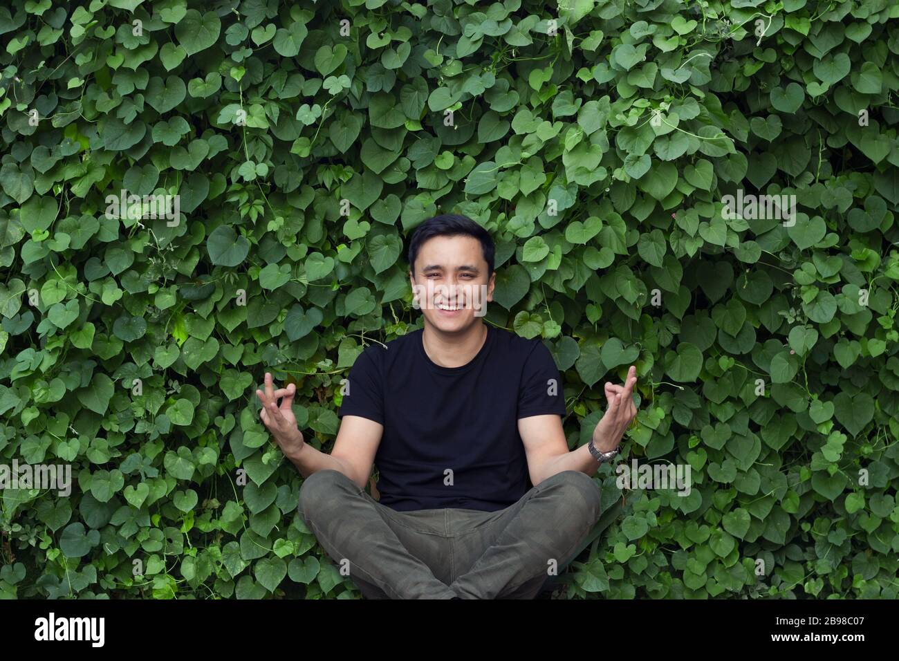 smiling asian young man posing yoga Stock Photo