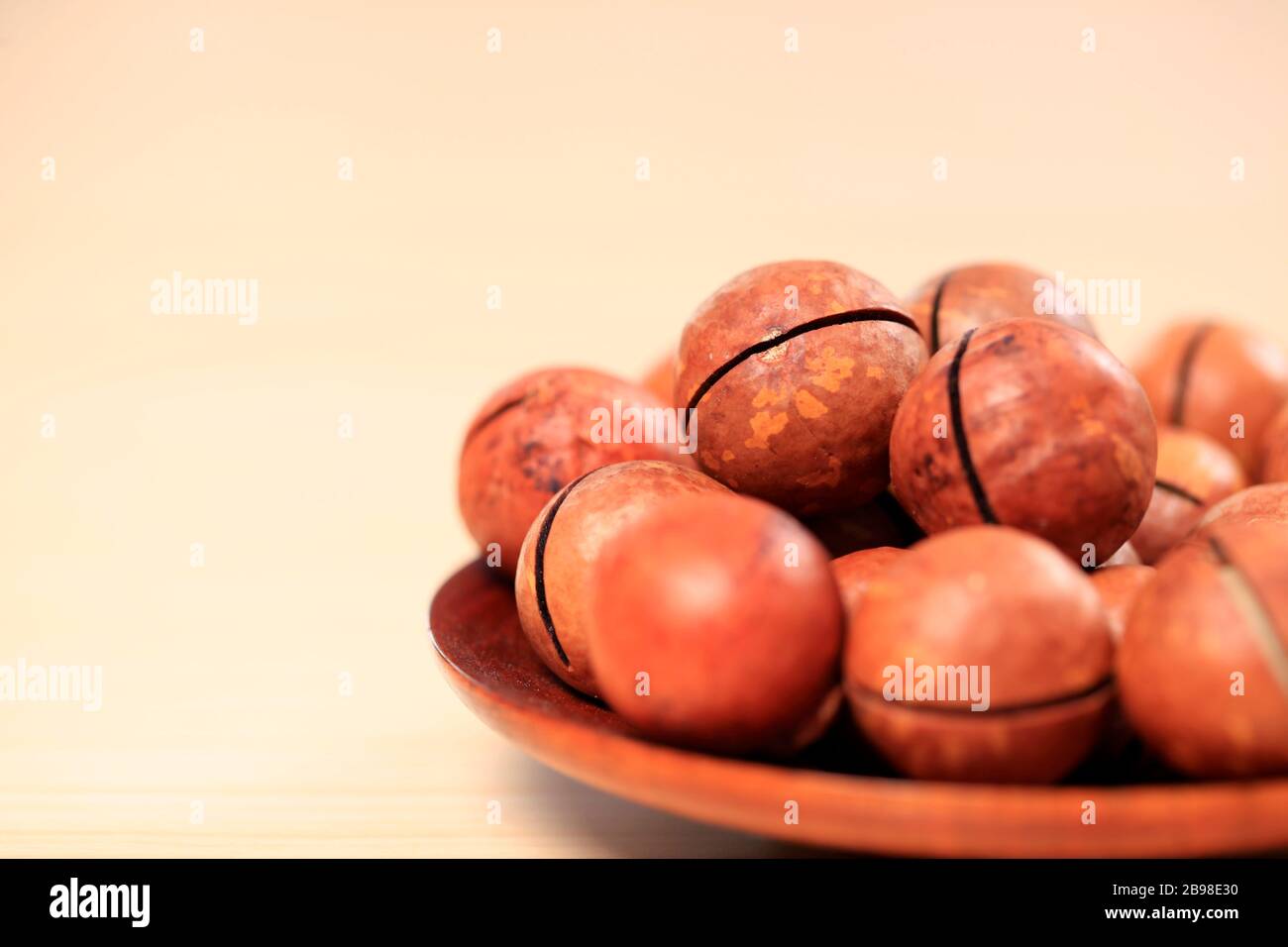 Macadamia nuts on a wooden background Stock Photo
