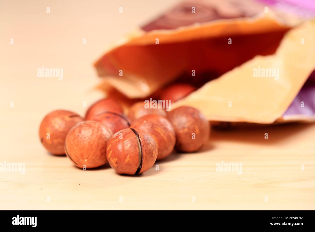 Macadamia nuts on a wooden background Stock Photo