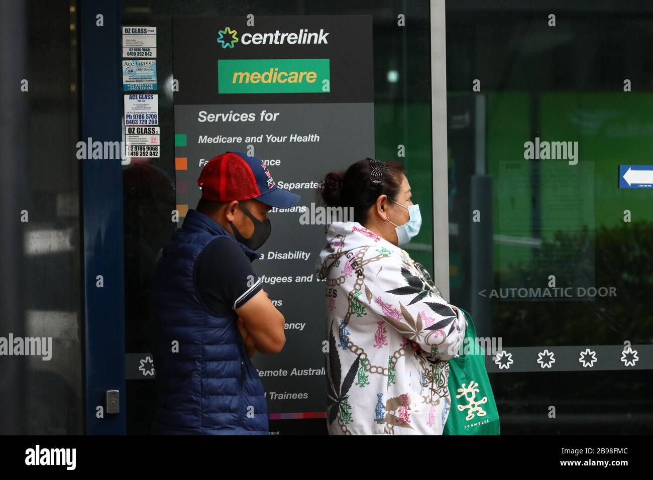 SYDNEY, AUSTRALIA, 24 Mar 2020, People line up to visit a Centrelink service centre in Burwood, Sydney, after job losses from coronavirus have prompted a surge in demand for unemployment payments. Credit: Sebastian Reategui/Alamy Live News Stock Photo