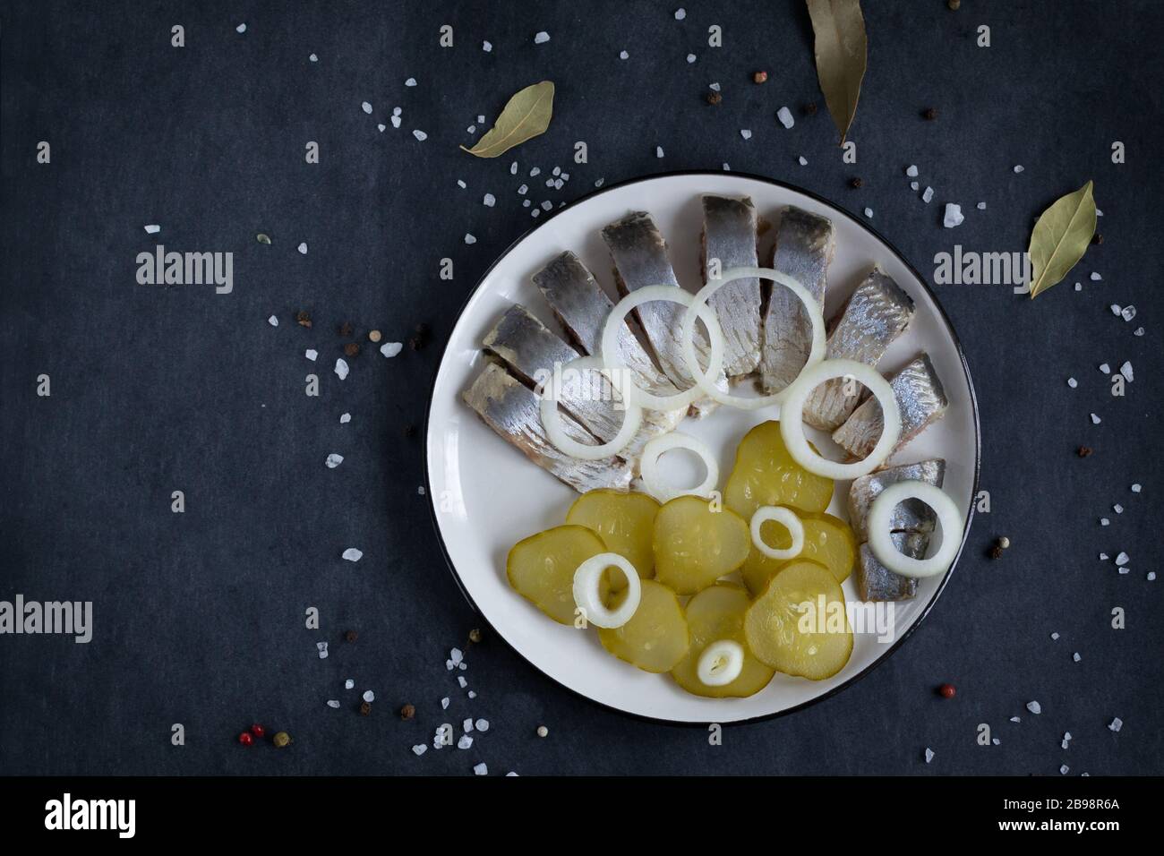 Pickled herring with pickles and onion rings. Traditional dutch food