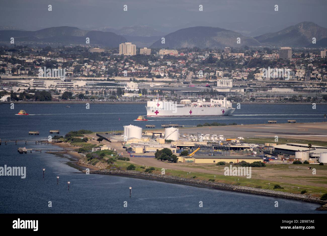 San Diego, California, USA. 23rd Mar, 2020. USNS Mercy, one of two US Navy hospital ships, departs San Diego Monday afternoon, March 23, 2020. Mercy is being deployed to the Los Angeles Harbor to provide overflow medical care with the goal of freeing up traditional hospital space for COVID-19 patients. Credit: David Barak/ZUMA Wire/Alamy Live News Stock Photo