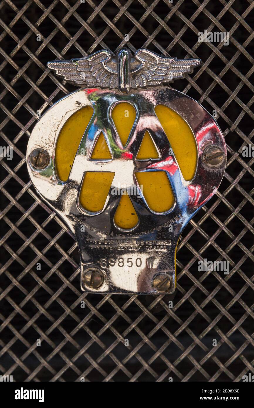 Vintage shiny polished chrome metal Automobile Association AA car badge  with yellow background mounted on wire radiator grille of Austin Mortis car  Stock Photo - Alamy