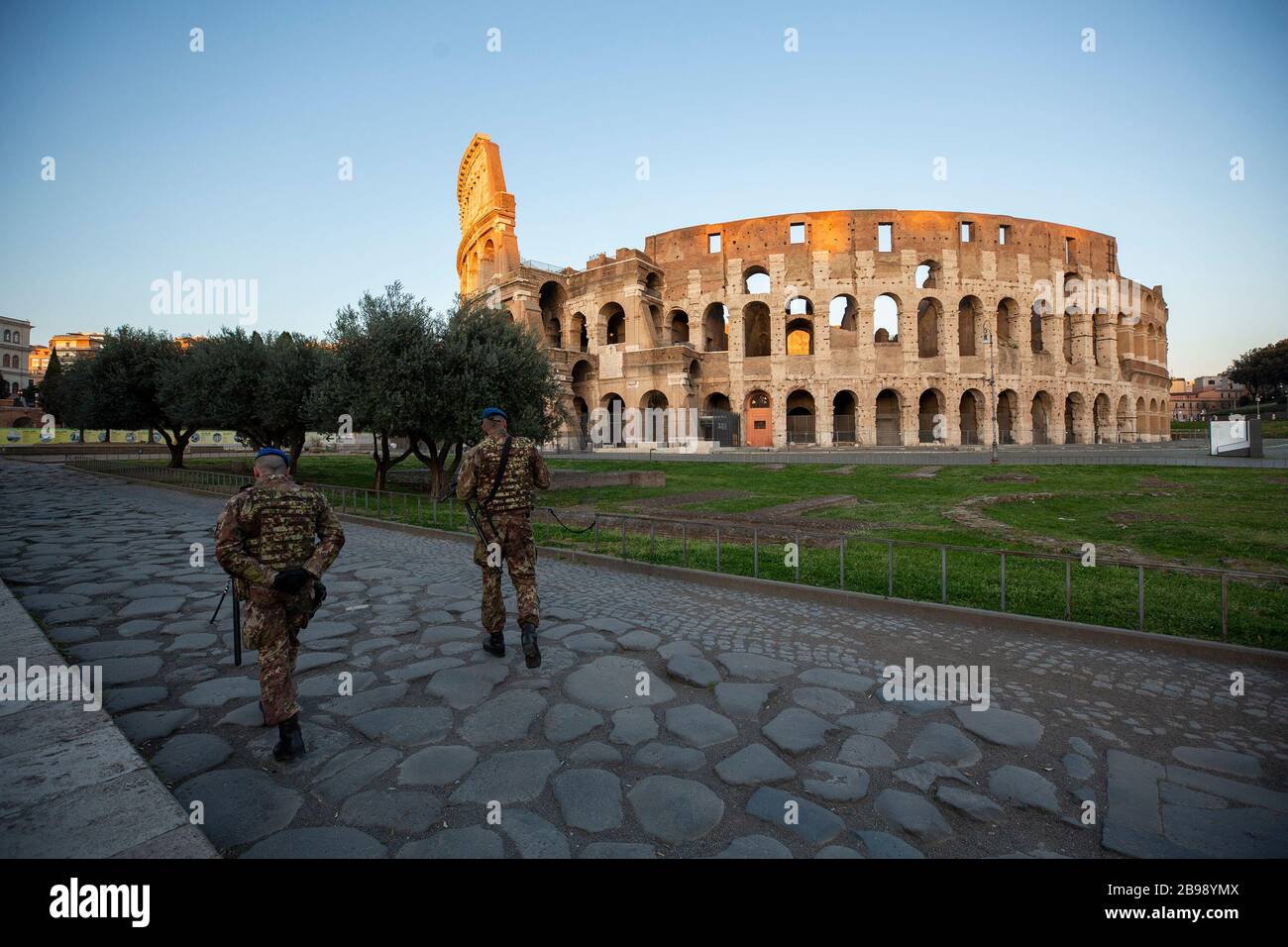 Roma, Italy. 23rd Mar, 2020. Two soldiers walking in front of the Colosseum in Rome during the 14th day of lockdown imposed nationwide by the Italian government that tries to tackle the coronavirus outbreak. Every movements in the citiies are restricted, and streets usually filled with life and traffic are almost empty (Photo by Giuseppe Fama/Pacific Press) Credit: Pacific Press Agency/Alamy Live News Stock Photo