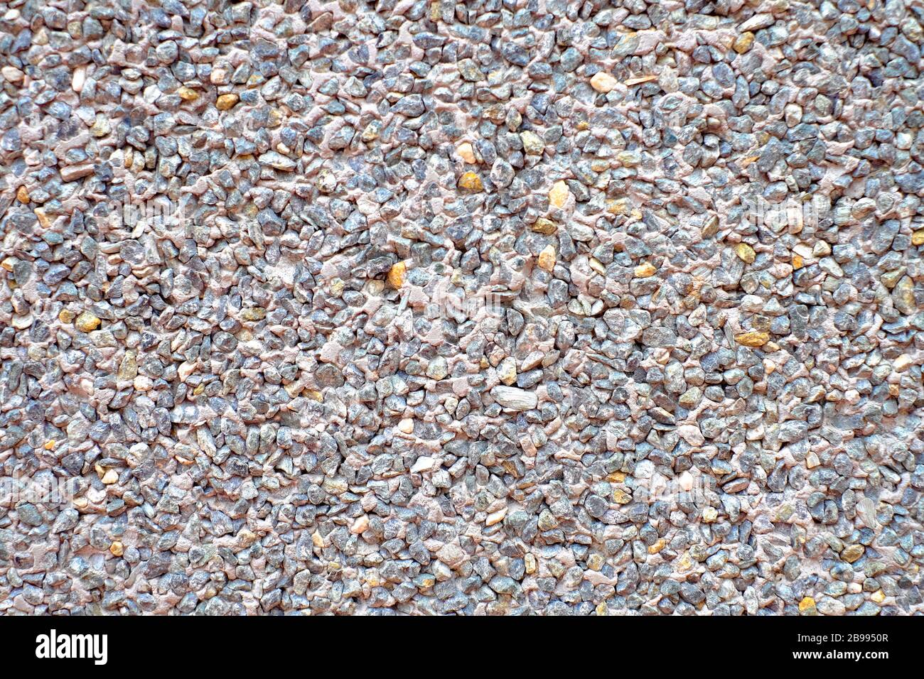 Large coarse texture, rough decorative exterior pattern with small stones and concrete finish. Stock Photo