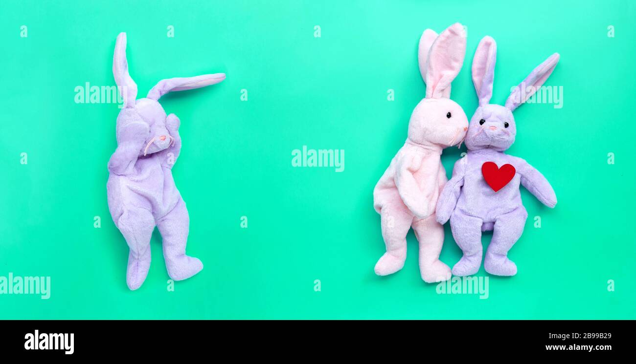 Broken heart rabbit toy with rabbit couple in love on green background ...