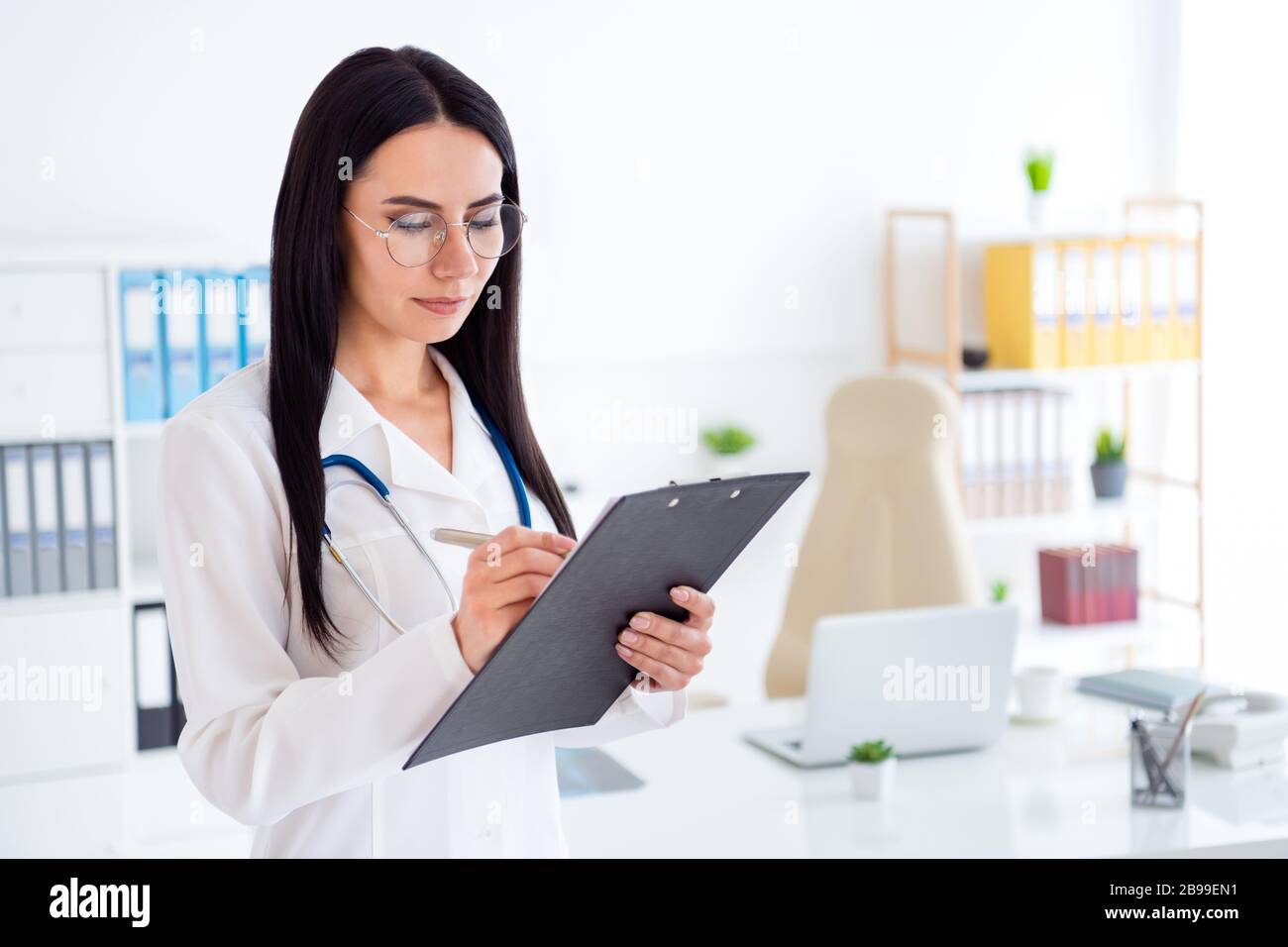 Photo of beautiful professional doc lady intern hold hands clipboard ...