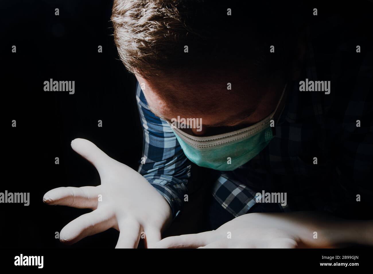 affraid man hands social distancing with medical gloves and mask for protection from corona virus covid-19 Stock Photo