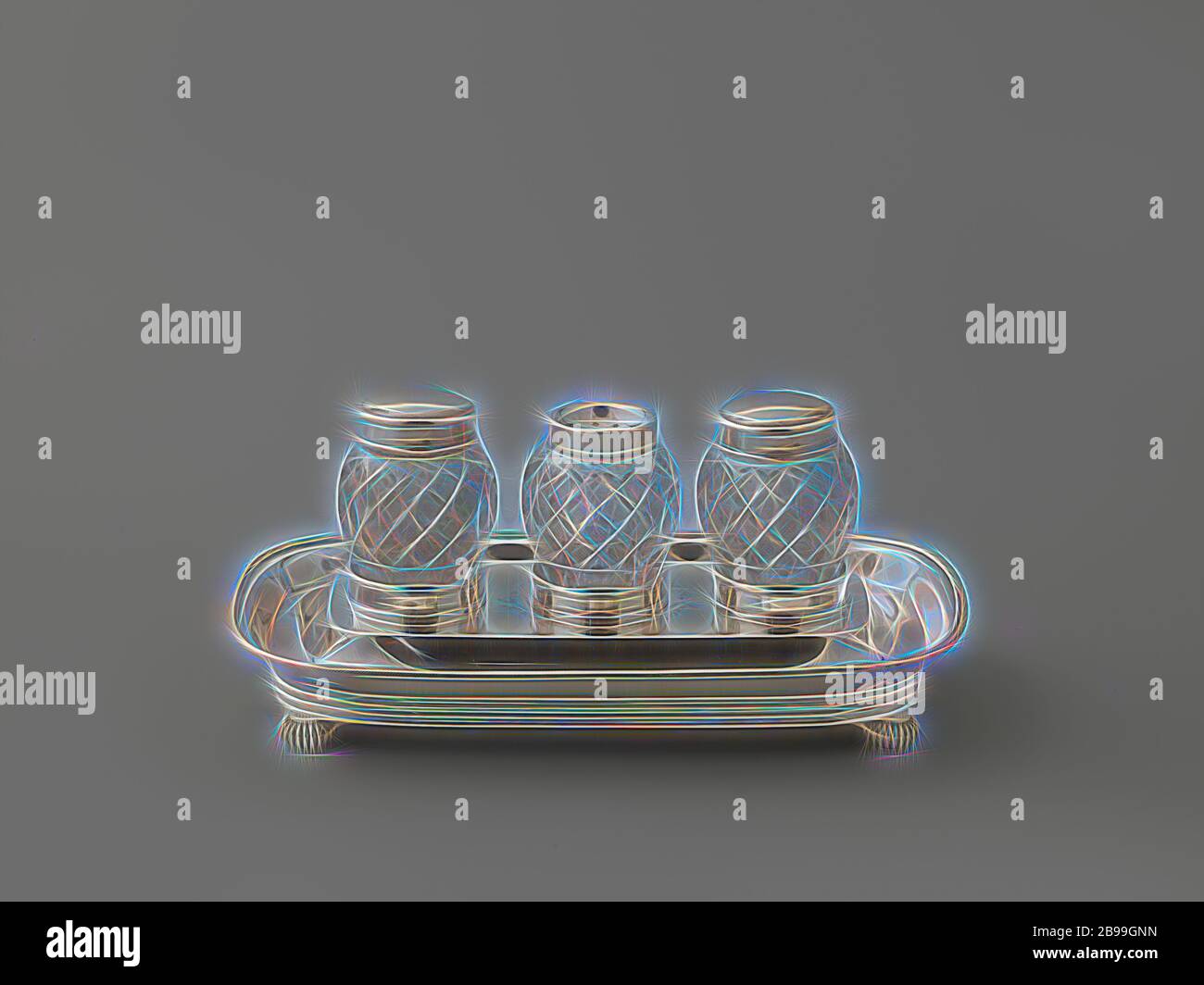 Ink set, rounded rectangular, with three glass jars, The rectangular sheet with rounded corners rests on four printed, spherical, ribbed legs. The wall is made up of a straight, ribbed band and a smooth arched section, along which a cable edge runs at the top. There are three cylindrical, low holders with profiled lower and upper edges on the raised central part of the blade. Three barrel-shaped jars of colorless glass fit in, decorated with a polished diamond pattern. The middle pot has a fixed silver lid, in which a pattern is sawn from a stylized flower surrounded by asterisks. A smooth sil Stock Photo