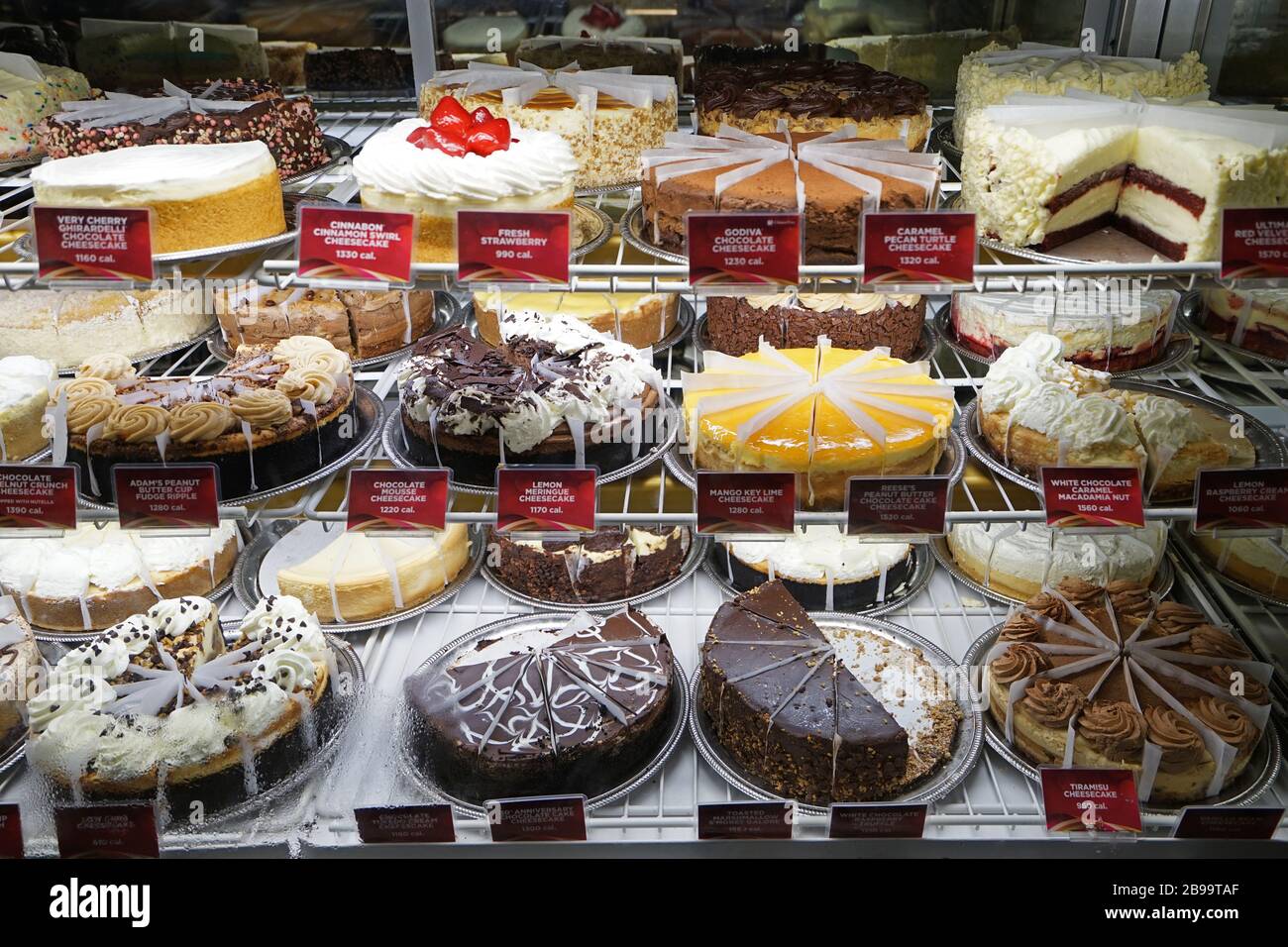 Assorted flavor bakery cakes in display showcase of local