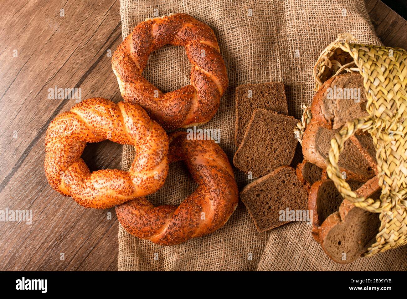 Bagel and slices of dark bread in basket Stock Photo