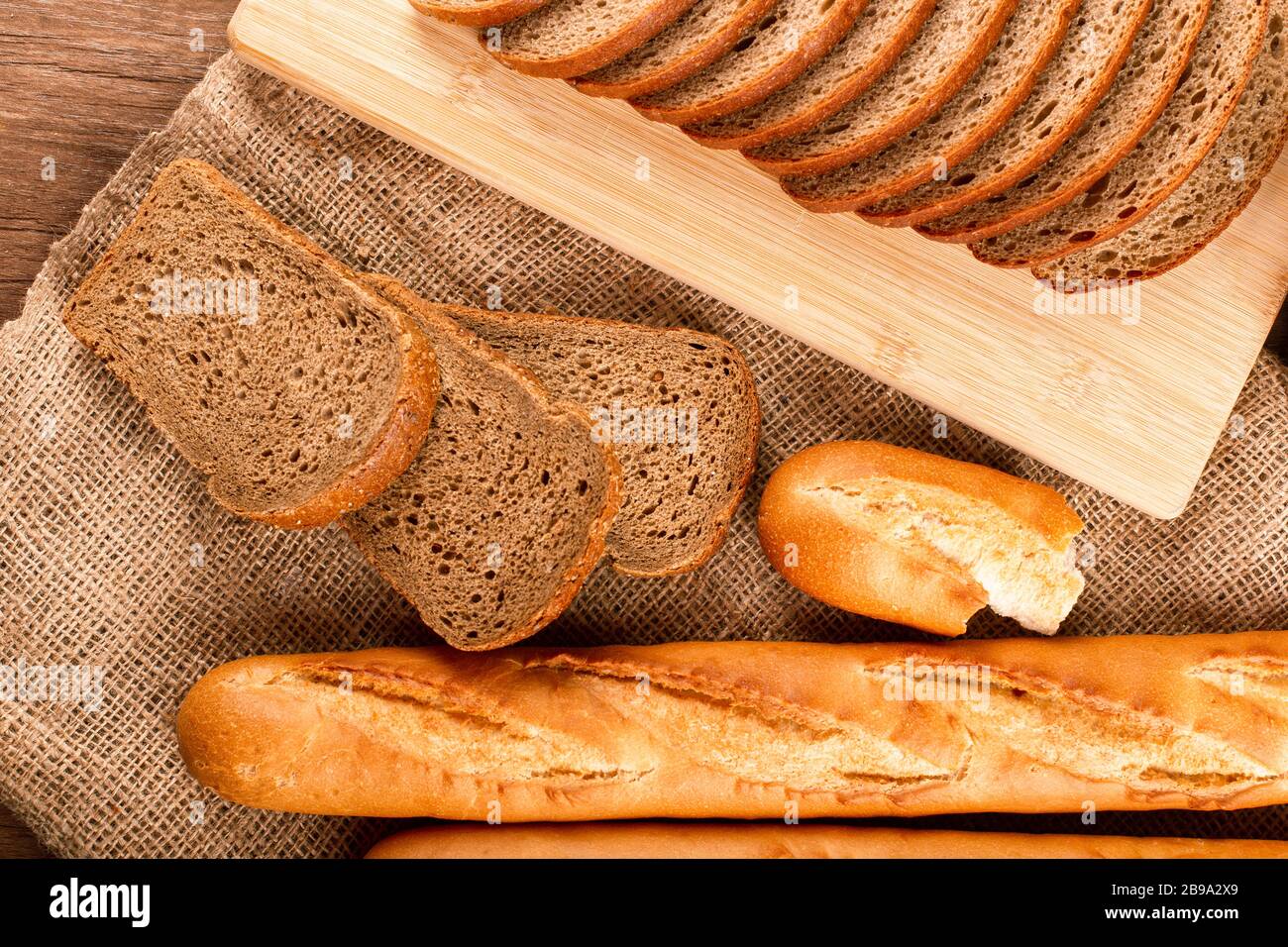 French baguette with slices of bread Stock Photo Alamy