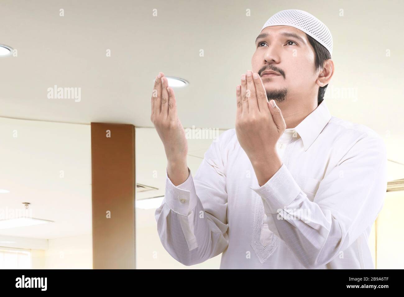 Muslim man standing praying inside hi-res stock photography and images ...