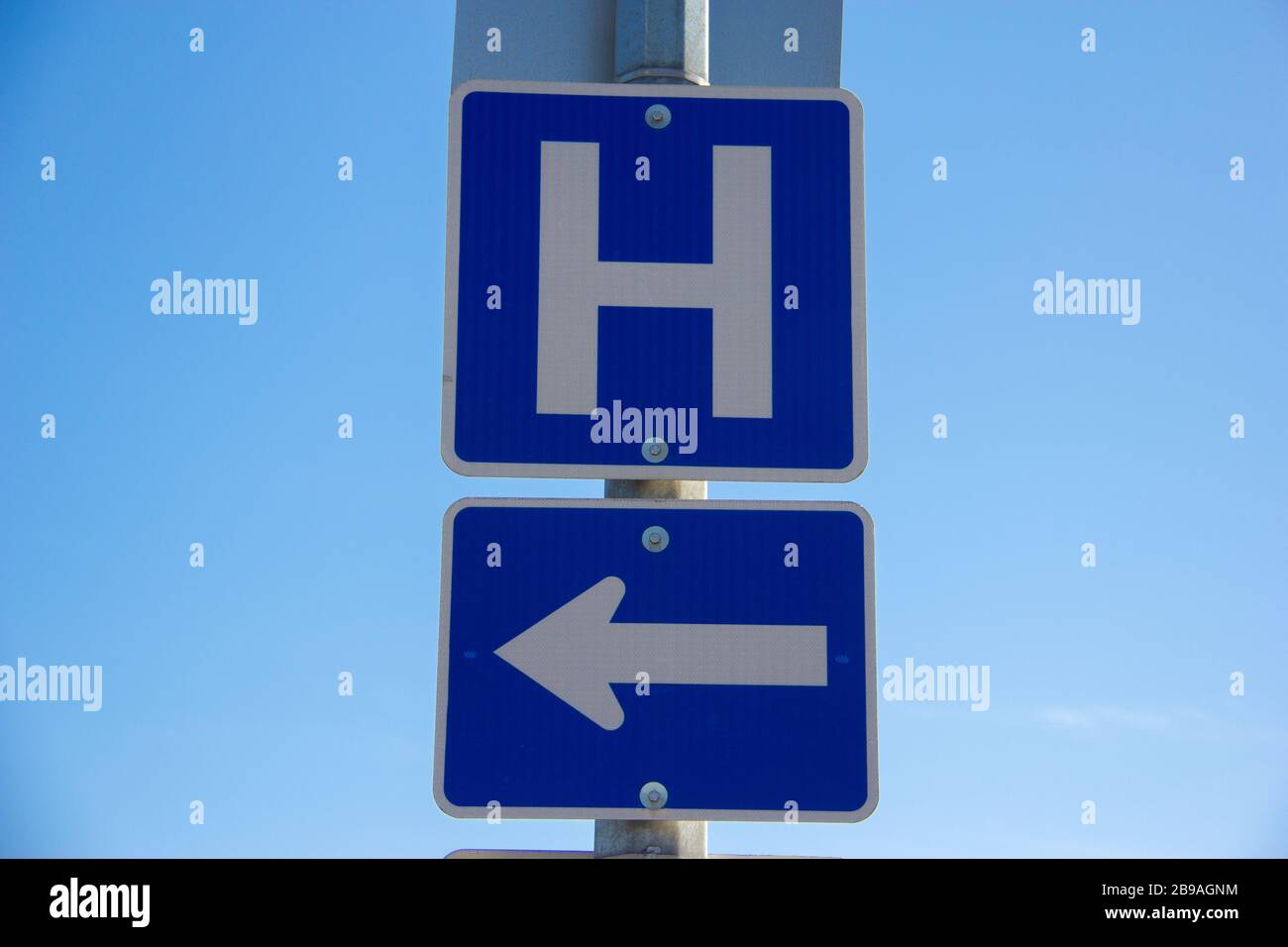 Turn left for hospital sign Stock Photo