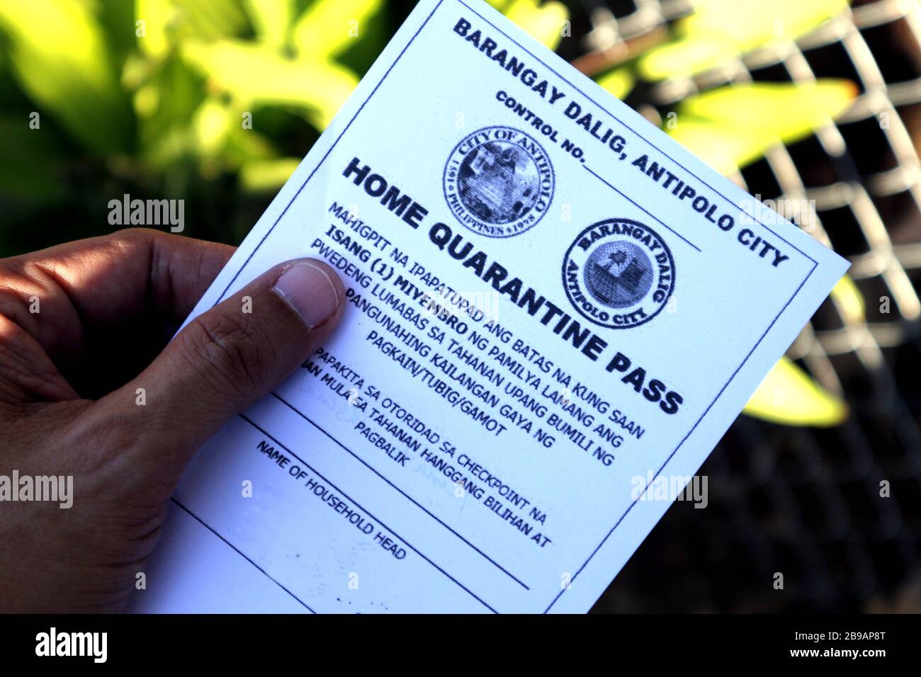 Antipolo City, Philippines - March 21, 2020: Home Quarantine Pass of a family member issued by local government during the Enhanced Community Quaranti Stock Photo