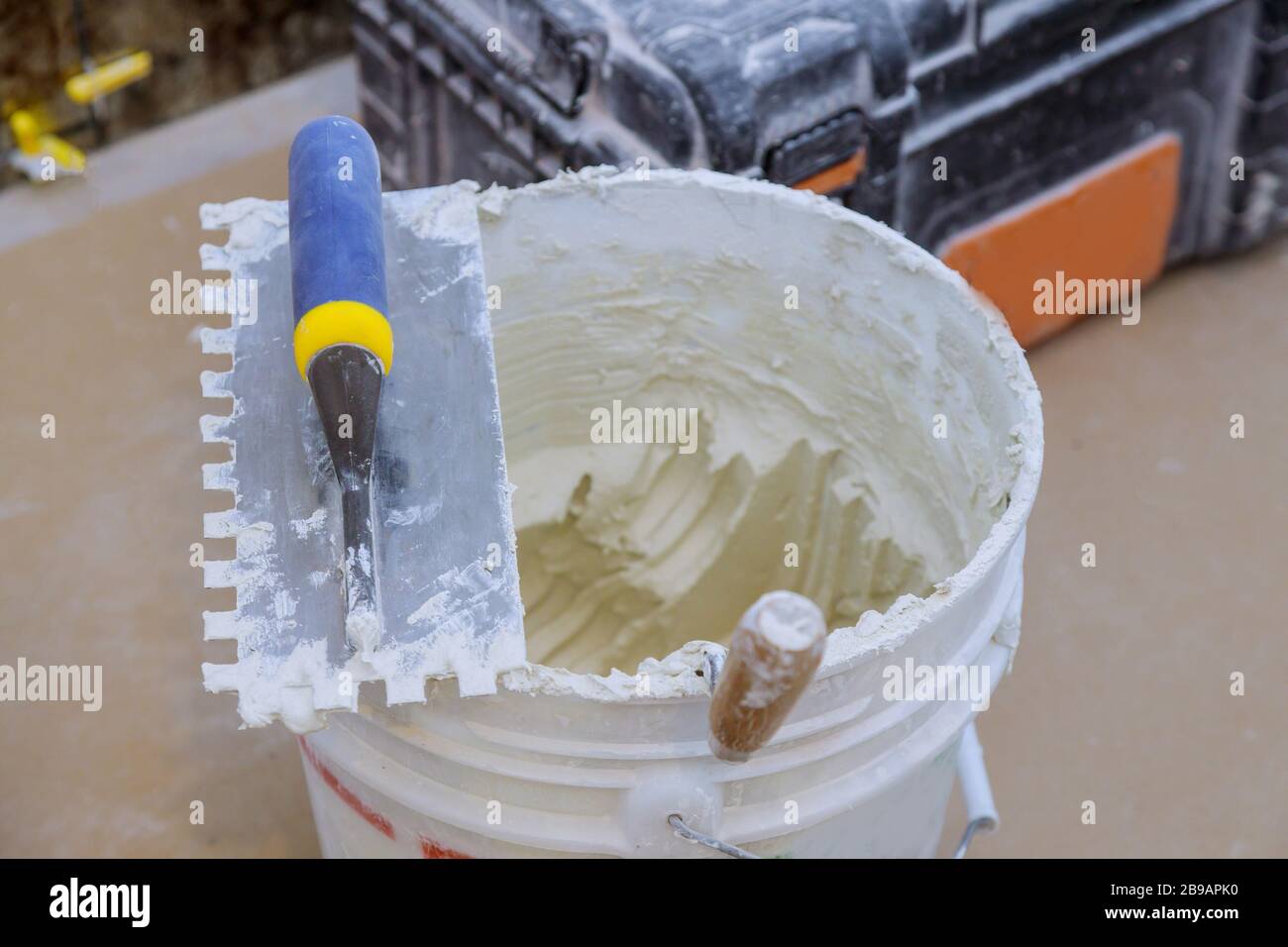 Trowel mortar tIling a closeup with new cement trowel ceramic tiles