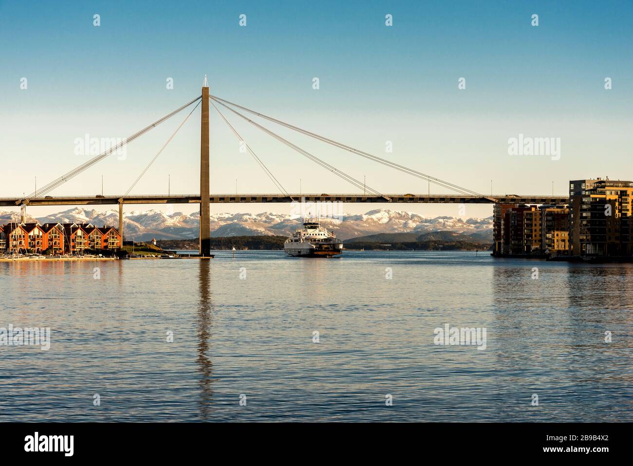 A passenger regular ferry from Stavanger to Tau passes under a city bridge  in Stavanger, Norway, December 2017 Stock Photo - Alamy