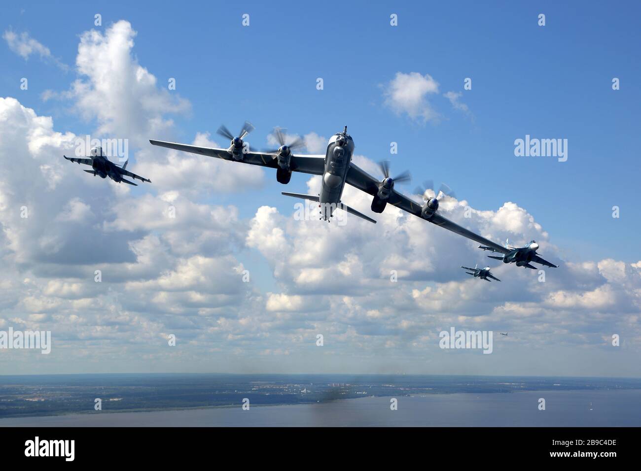 Tu-142MZ airplane in formation with Su-33 jet fighters of the Russian Navy. Stock Photo