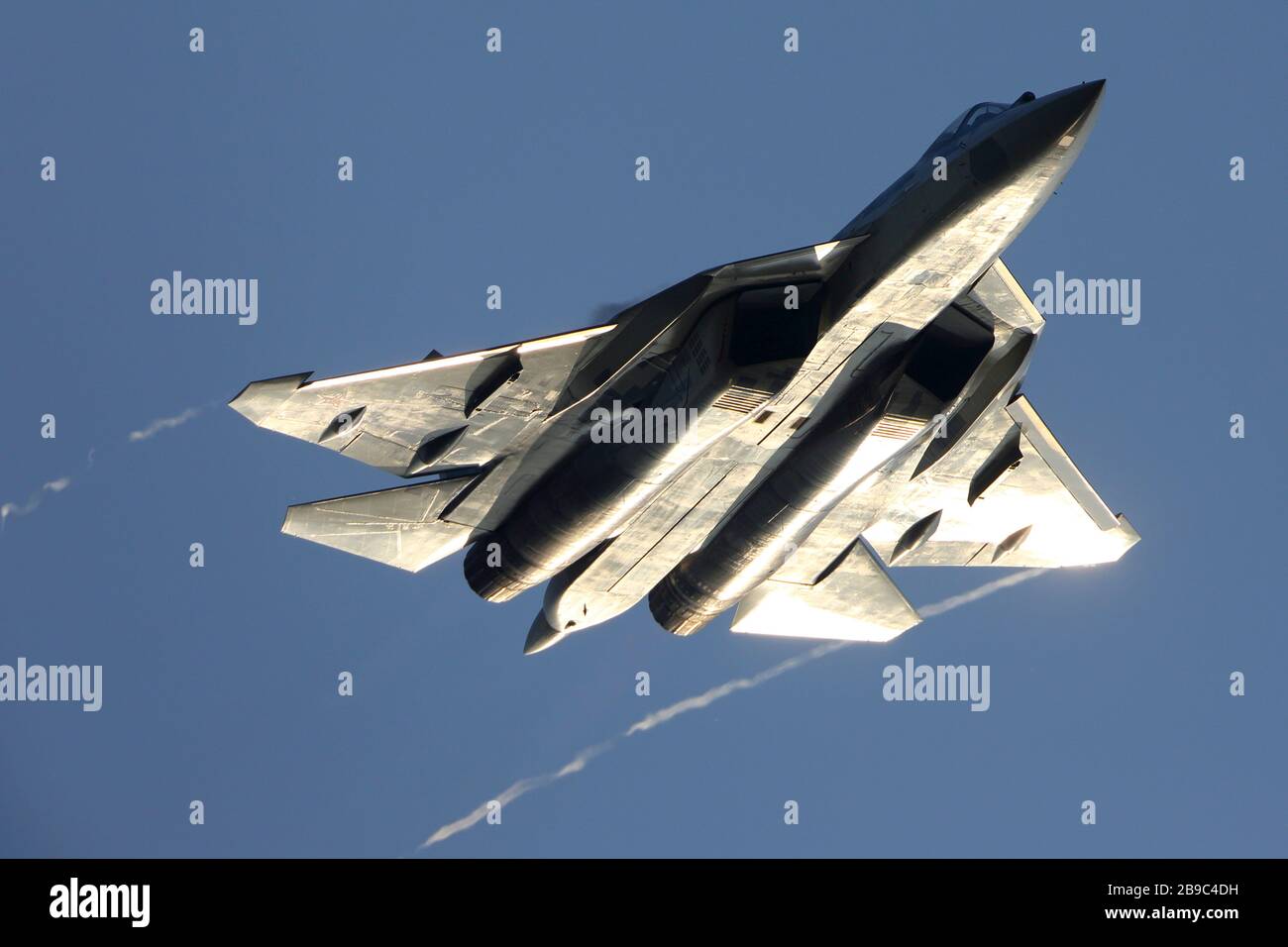 Su-57 jet fighter of the Russian Air Force against a blue sky. Stock Photo