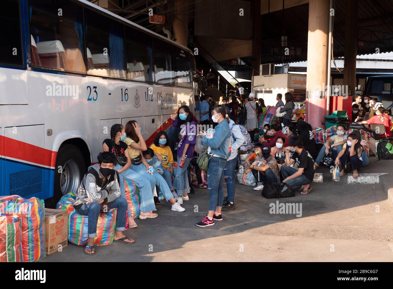 People wait for buses at the Mochit bus station in Bangkok. Thousands of people chose to depart