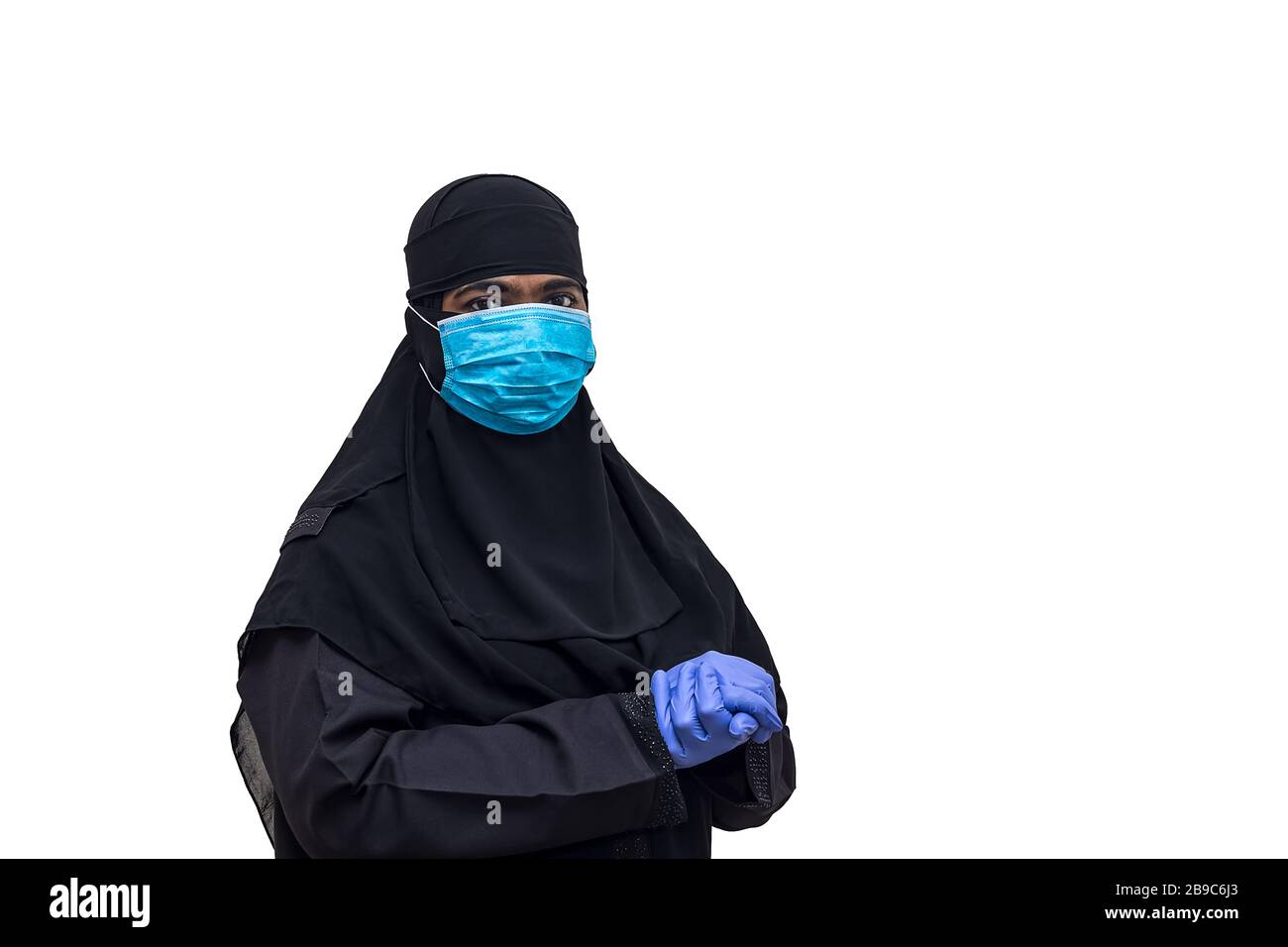 Muslim woman wearing medical face mask with hand gloves - Stay at home, Be safe and safe others. Concept of COVID-19 or Coronavirus quarantine. Stock Photo