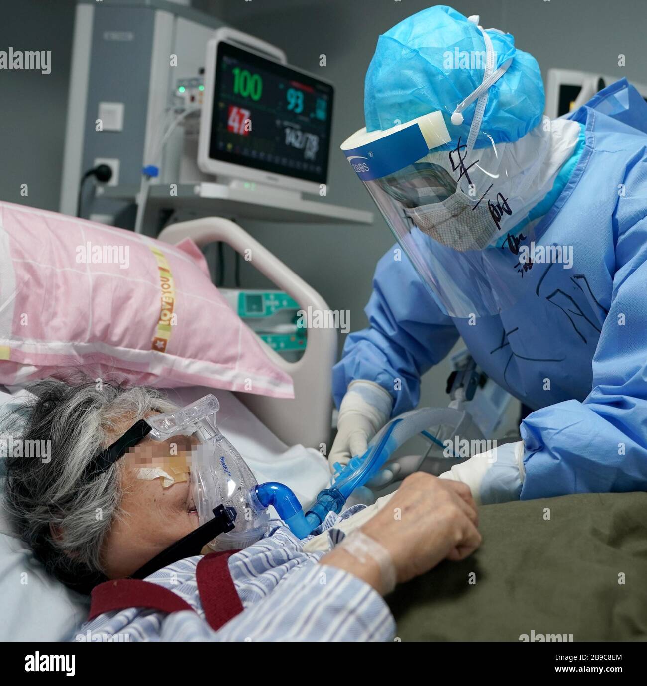 Beijing, China's Hubei Province. 20th Mar, 2020. Nurse Zhu Li adjusts devices for a patient at the makeshift Huoshenshan (Fire God Mountain) Hospital in Wuhan, capital of central China's Hubei Province, March 20, 2020. Credit: Wang Yuguo/Xinhua/Alamy Live News Stock Photo