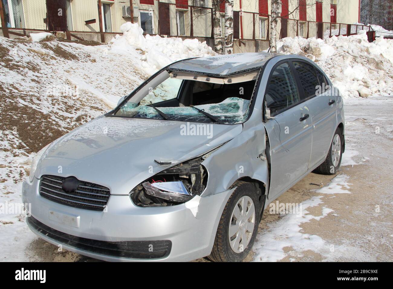 A broken silver car after an accident on the road. Transport security concept. Stock Photo