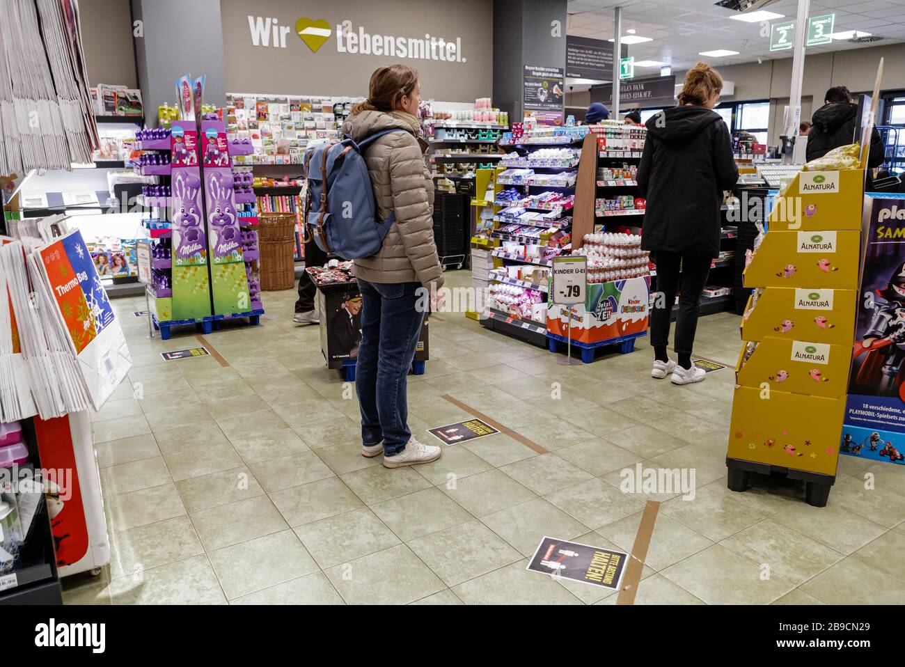 Berlin, Germany. 23rd Mar, 2020. Customers wait for checkout at a  supermarket in Berlin, capital of Germany, March 23, 2020. The German  government has approved the "largest aid package" in the country's