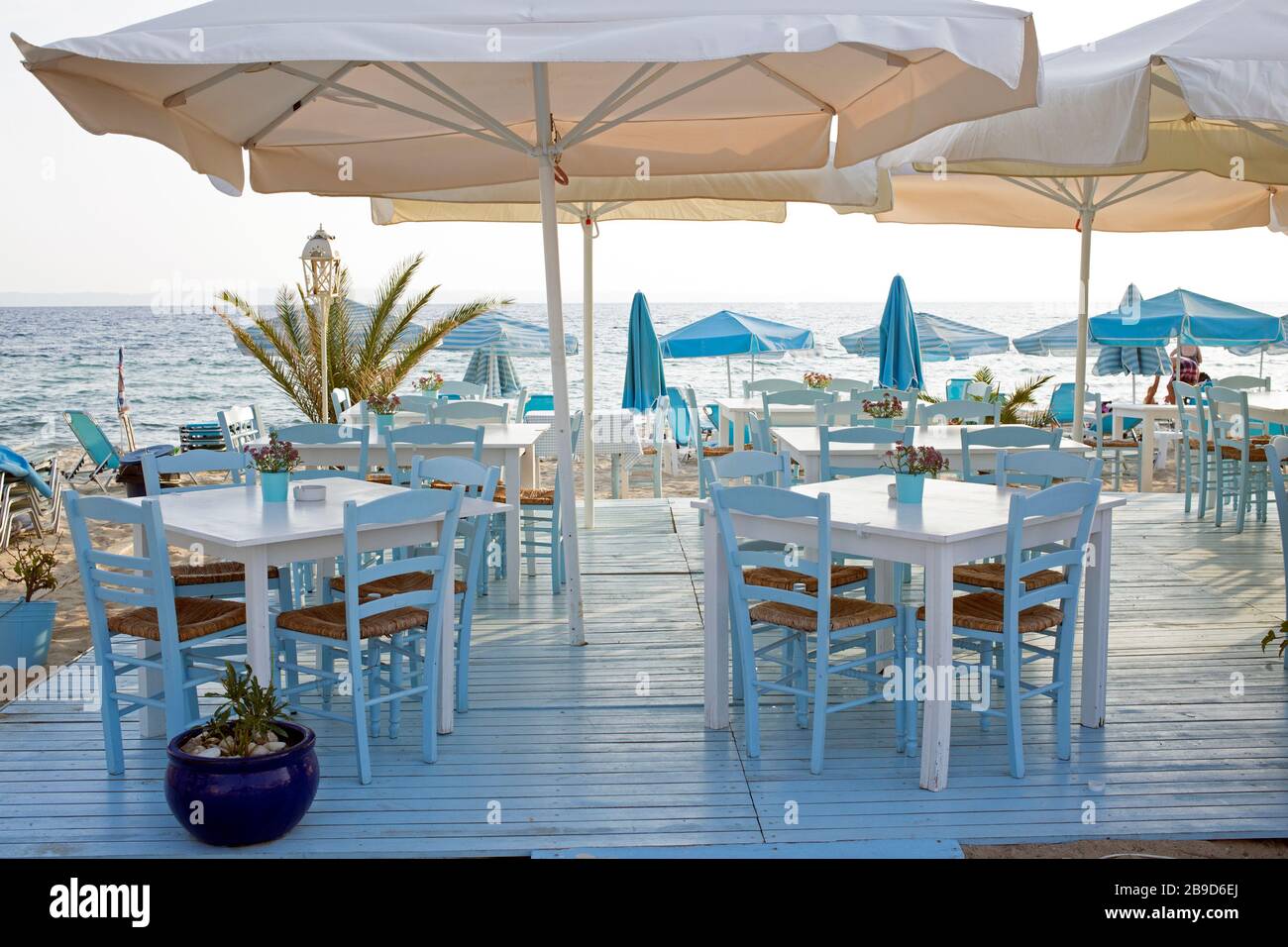 Beautiful blue greek restoraunt overlooking the see. Patio with tables